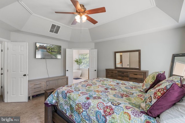 bedroom with ensuite bathroom, carpet floors, visible vents, a ceiling fan, and a raised ceiling