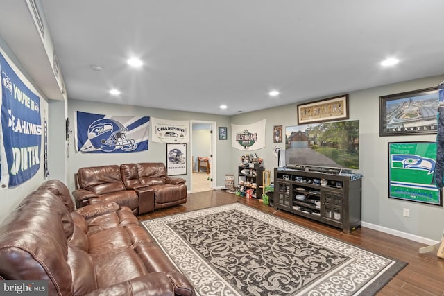 living room featuring baseboards, wood finished floors, and recessed lighting