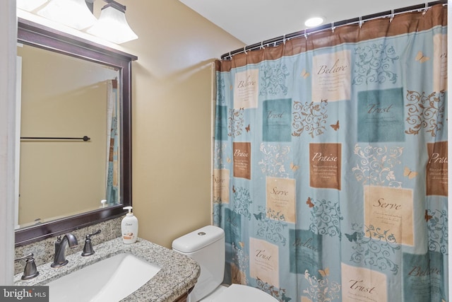 bathroom with toilet and vanity