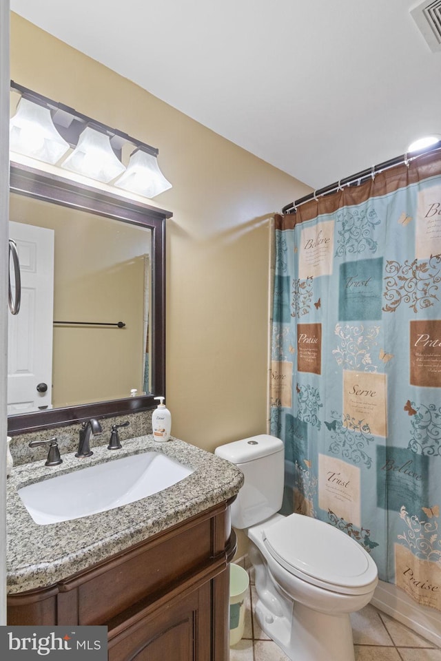 bathroom featuring visible vents, a shower with shower curtain, toilet, vanity, and tile patterned floors