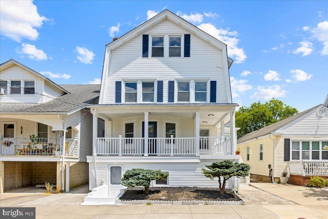 view of front of property with covered porch and a shingled roof