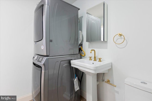 clothes washing area with laundry area and stacked washer / drying machine