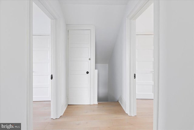 interior space featuring vaulted ceiling and light wood-style floors