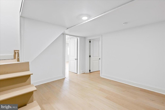 interior space with baseboards and wood finished floors