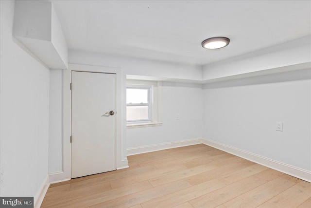 unfurnished room featuring baseboards and wood finished floors