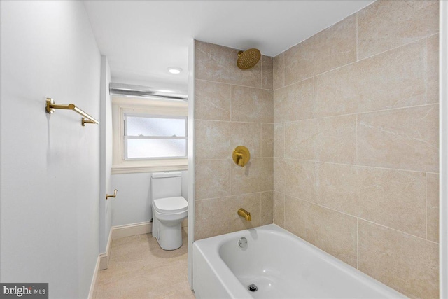 full bathroom featuring toilet, baseboards, and bathing tub / shower combination