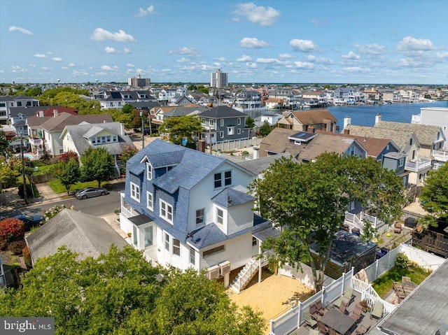 drone / aerial view with a water view and a residential view