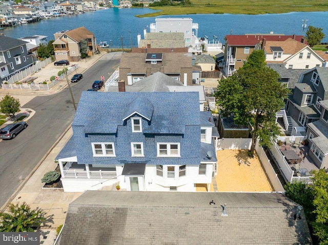 birds eye view of property with a residential view and a water view