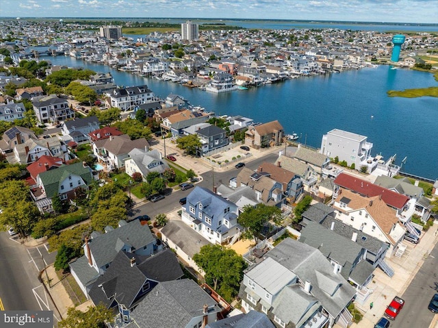 birds eye view of property with a water view and a residential view