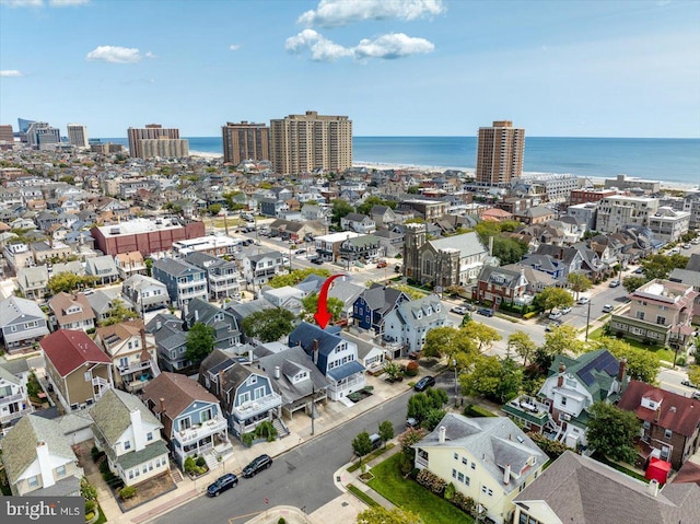 birds eye view of property featuring a water view and a city view