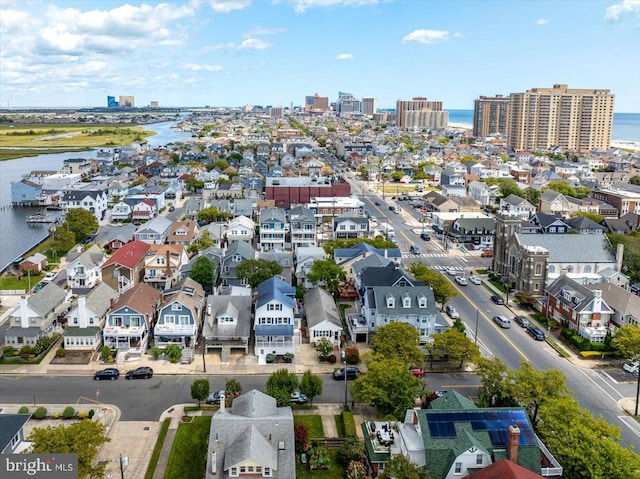 birds eye view of property with a water view and a city view