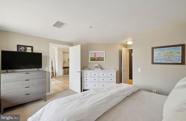 bedroom featuring light carpet and visible vents