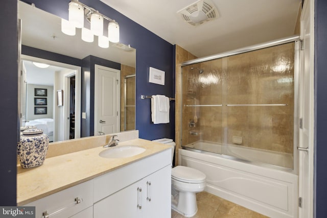 full bath with visible vents, bath / shower combo with glass door, toilet, tile patterned flooring, and vanity