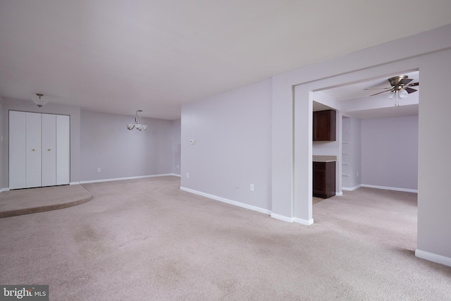 13213 Dairymaid Dr Unit 20, Germantown, MD 20874 - unfurnished living room featuring baseboards, light carpet, a fireplace with flush hearth, and ceiling fan with notable chandelier