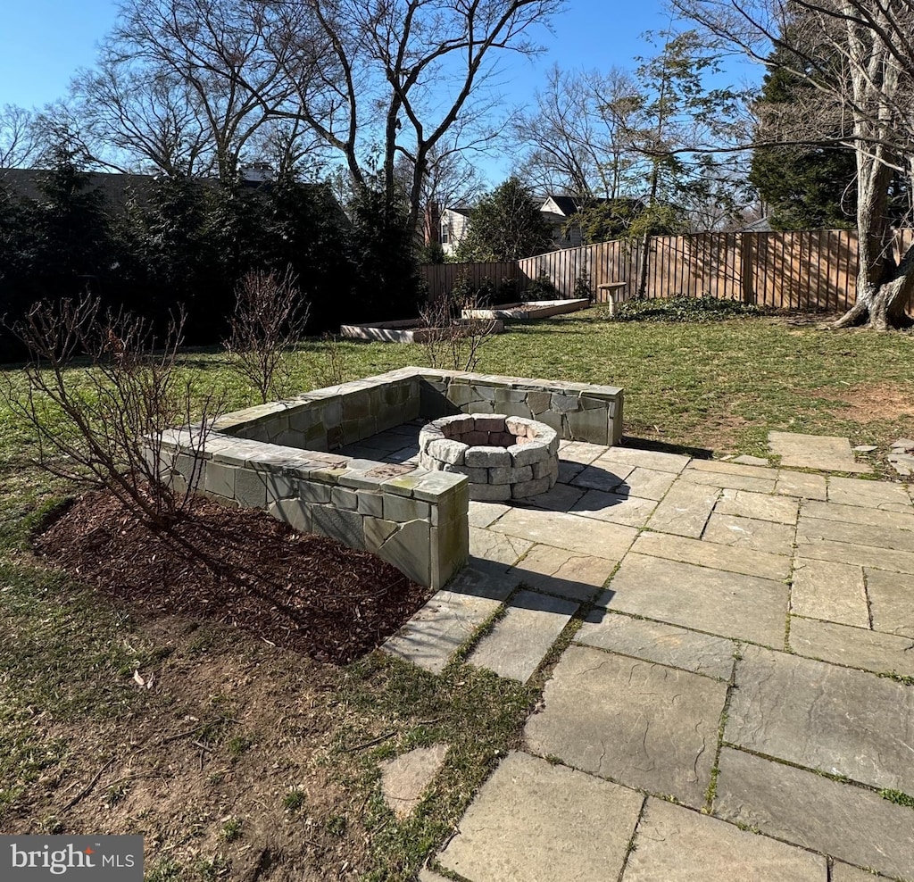 view of patio / terrace featuring a fire pit and fence