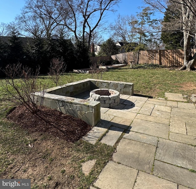 view of patio / terrace featuring a fire pit and fence