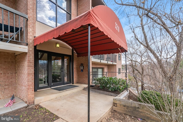 entrance to property featuring brick siding