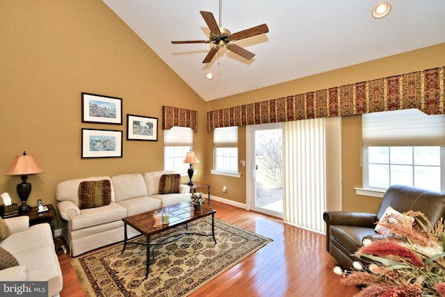 living room with high vaulted ceiling, recessed lighting, wood finished floors, a ceiling fan, and baseboards