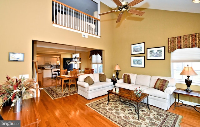 living room with ceiling fan and wood finished floors