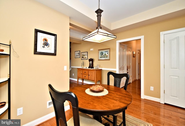 dining room with light wood-type flooring and baseboards