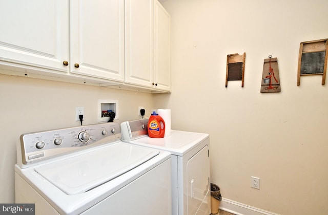 clothes washing area featuring cabinet space, baseboards, and washing machine and clothes dryer