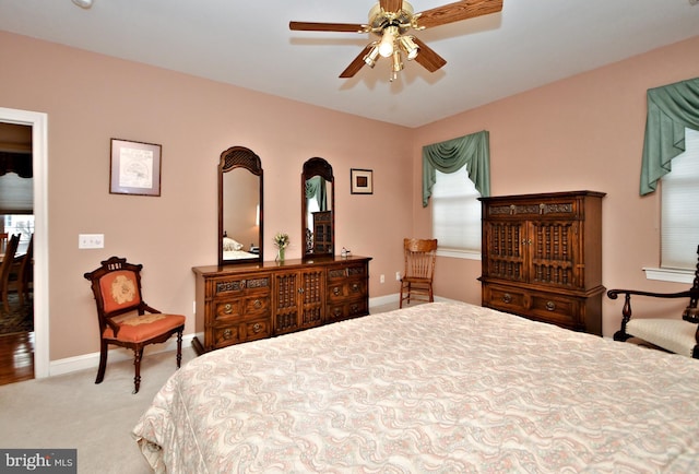 bedroom with a ceiling fan, carpet, and baseboards