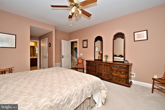 bedroom featuring carpet, visible vents, connected bathroom, ceiling fan, and baseboards