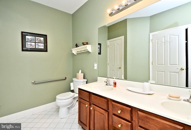 full bath with toilet, tile patterned flooring, double vanity, and a sink