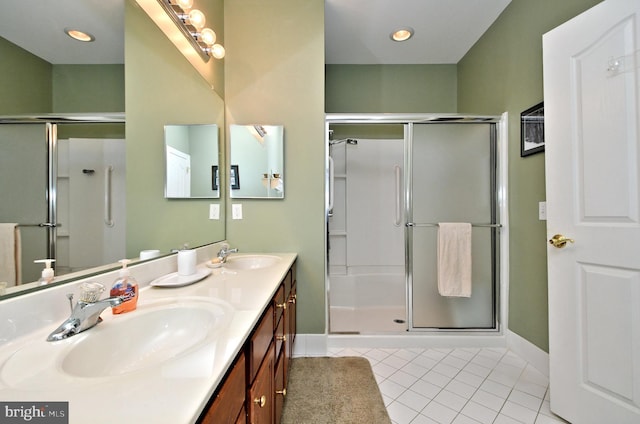 bathroom with a stall shower and a sink