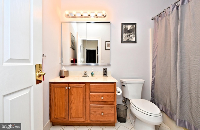 bathroom with a shower with curtain, vanity, toilet, and tile patterned floors