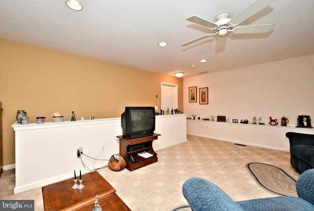 carpeted living room featuring baseboards, a ceiling fan, and recessed lighting