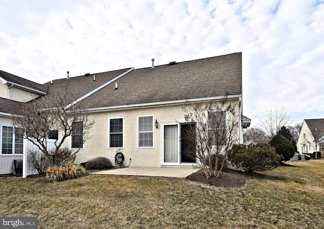 back of house featuring a patio, a lawn, roof with shingles, and stucco siding