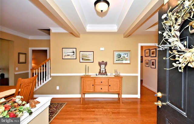 entrance foyer featuring light wood-type flooring, stairway, and ornamental molding