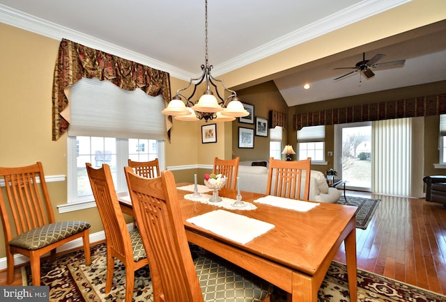 dining room with baseboards, a ceiling fan, lofted ceiling, ornamental molding, and wood finished floors