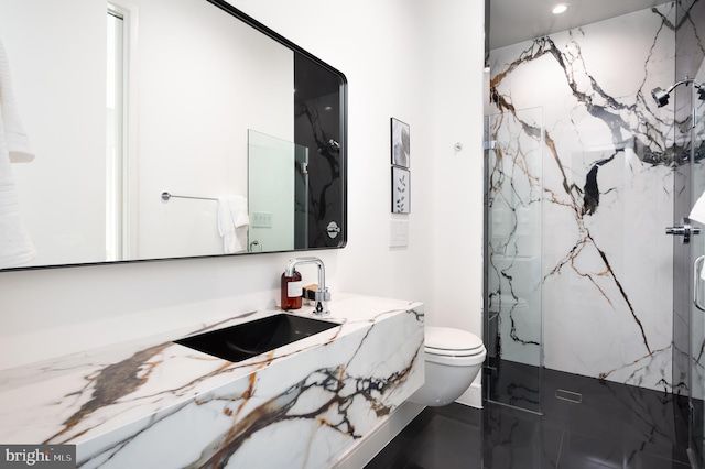 bathroom featuring toilet, recessed lighting, a marble finish shower, and vanity