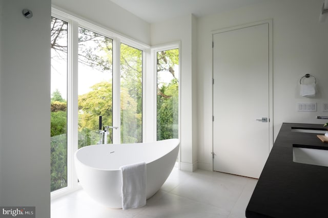 doorway to outside with light tile patterned flooring and a sink