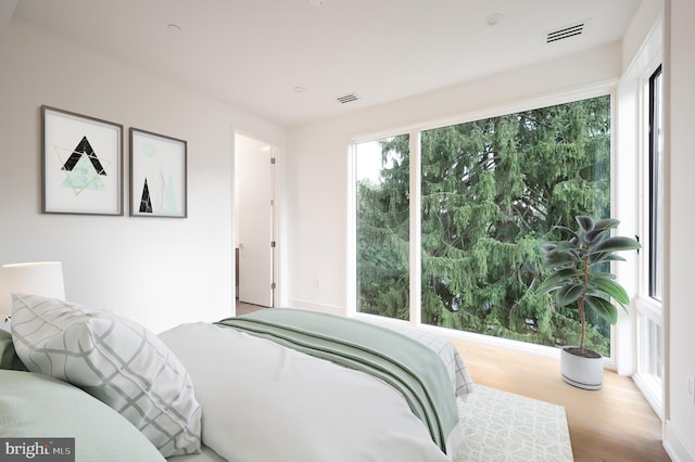 bedroom with visible vents and wood finished floors