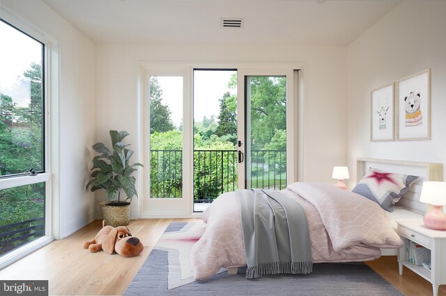 bedroom featuring visible vents and wood finished floors