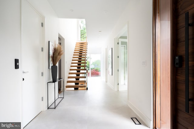 hall with stairway and baseboards