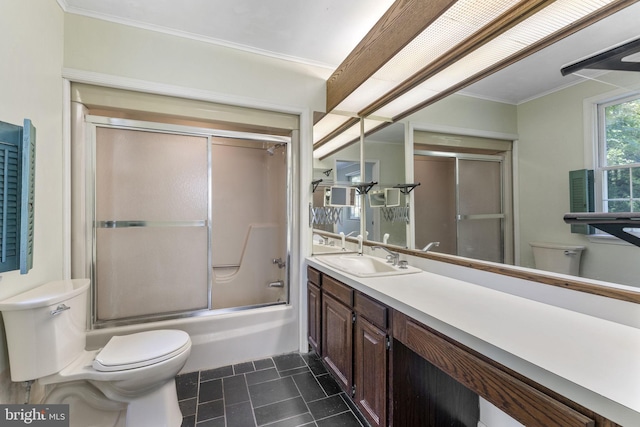 bathroom featuring ornamental molding, shower / bath combination with glass door, vanity, and toilet