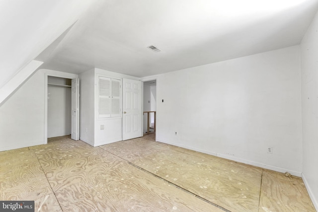 bonus room with lofted ceiling and visible vents