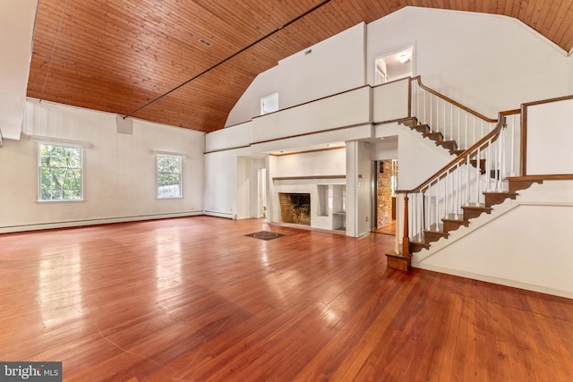 unfurnished living room featuring wood ceiling, stairway, a fireplace, and hardwood / wood-style flooring