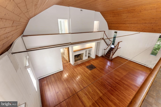 unfurnished living room featuring lofted ceiling, wood ceiling, and wood-type flooring