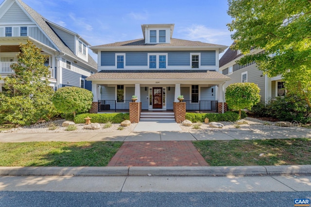 american foursquare style home with a porch