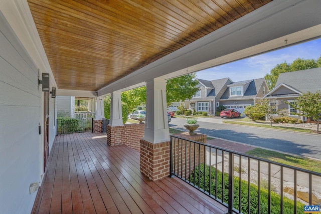 deck with a residential view and a porch