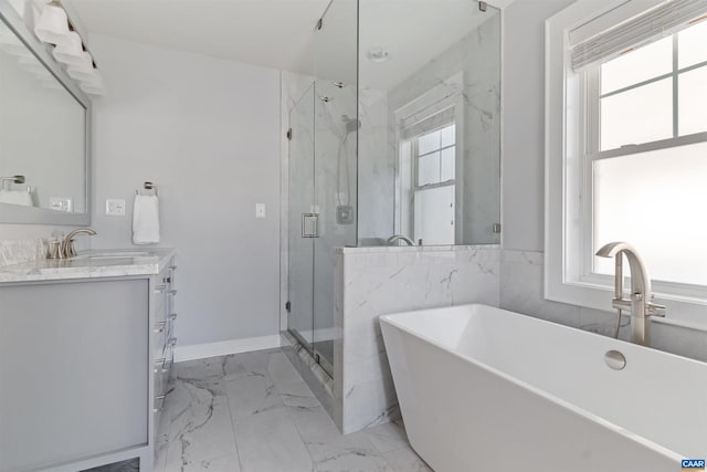 full bath with marble finish floor, vanity, a marble finish shower, and a wealth of natural light