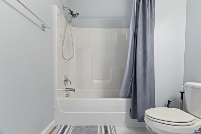 bathroom featuring tile patterned flooring, shower / tub combo, and toilet