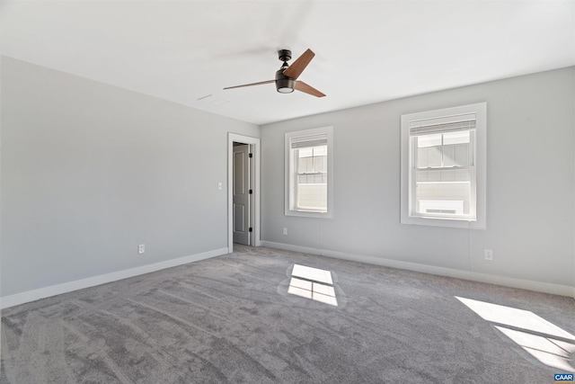 spare room featuring carpet floors, baseboards, and a ceiling fan