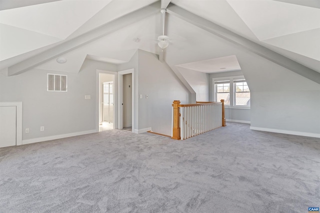 bonus room featuring lofted ceiling, carpet floors, visible vents, and baseboards