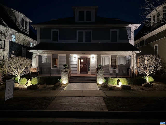 american foursquare style home featuring covered porch